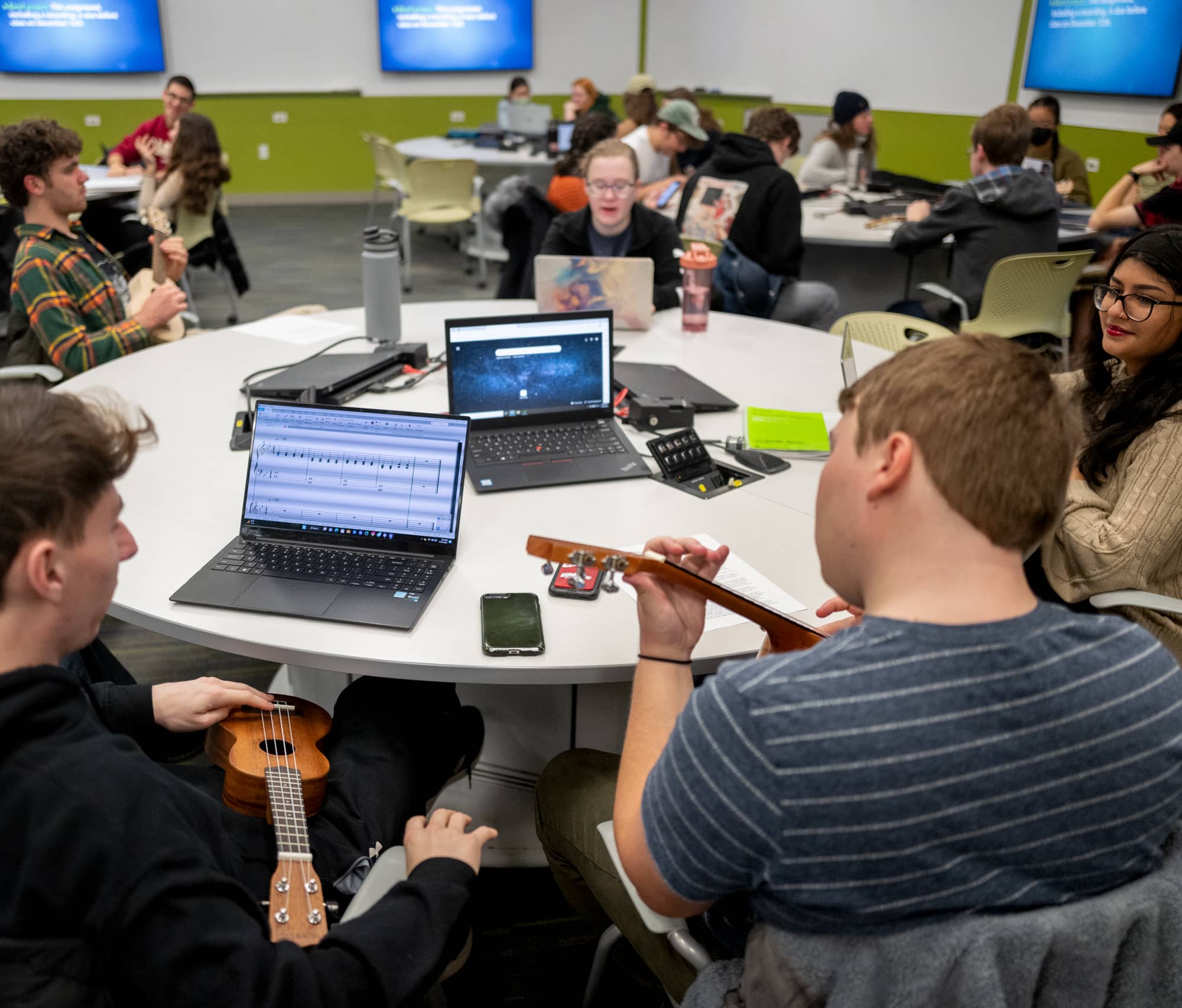 Students in class working with instruments and their computers