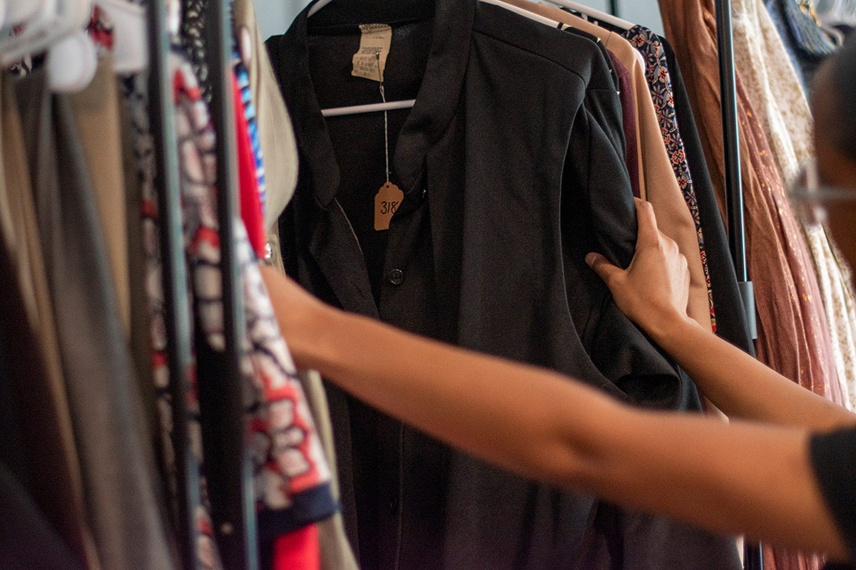 wardrobe with hand looking through clothing