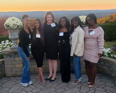 Photo 1: 2024 Healthcare Heroes Award Banquet. Pictured from left to right: C'Niyah Hines ’27, Shaely Lora-Brito ’27, Elaine Marieb College of Nursing Dean Allison Vorderstrasse, Josie Thomas ’27, Abena Ofori-Mensah ’27, and Student Success and Diversity Manager Krystal Bariffe