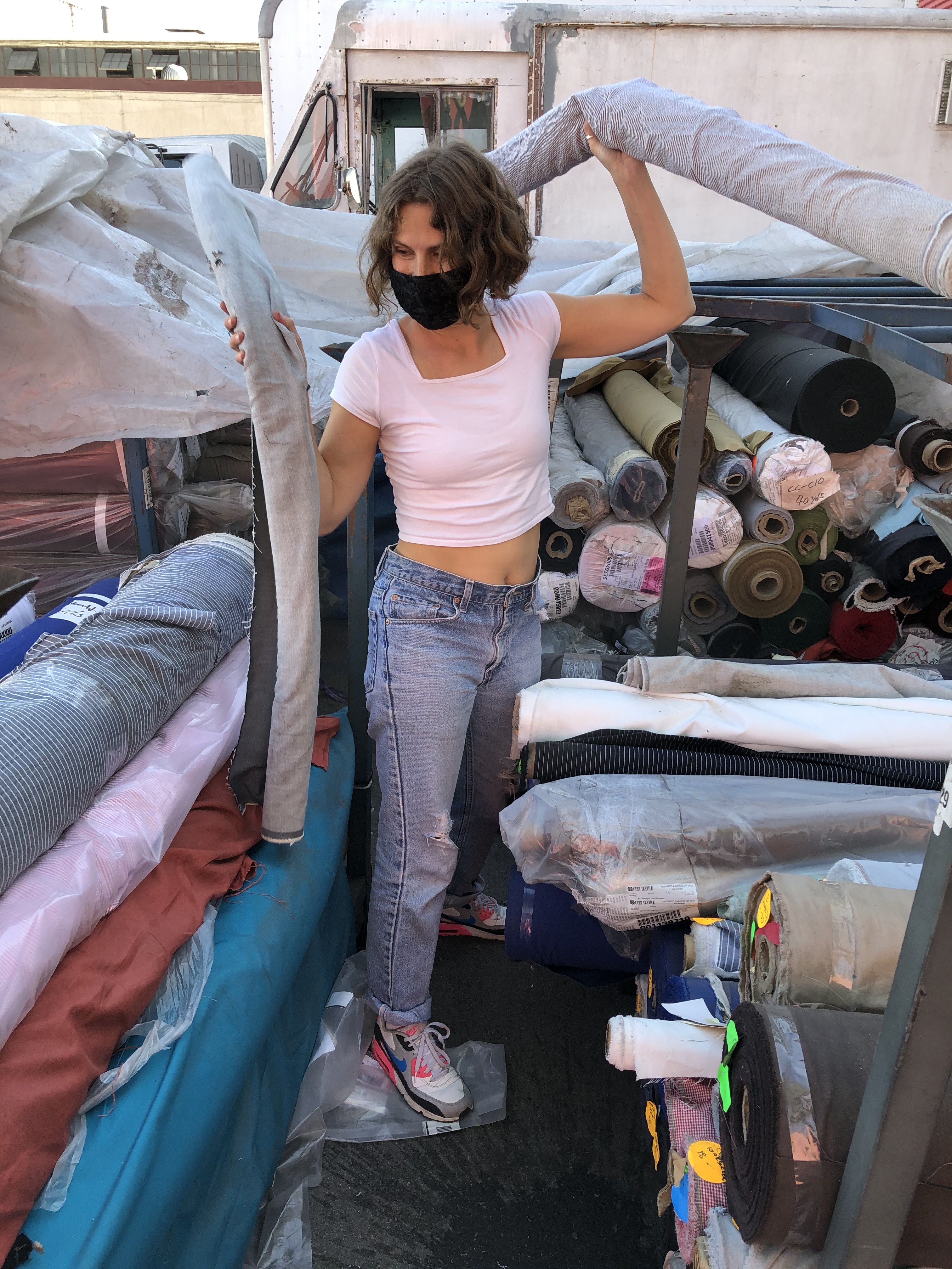 Jillian Clark collecting deadstock fabric from a factory in downtown LA during the Covid-19 pandemic.  