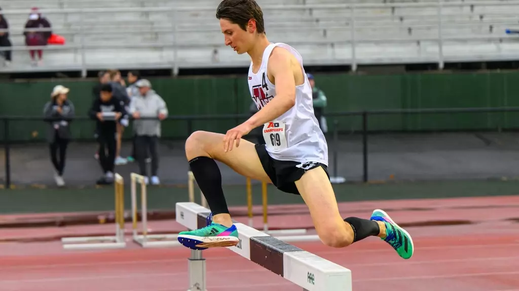 Runner jumping over hurdle