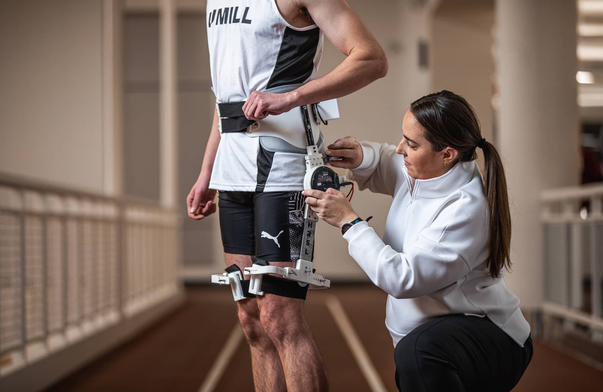 Athlete being fitted with physical assistive technology