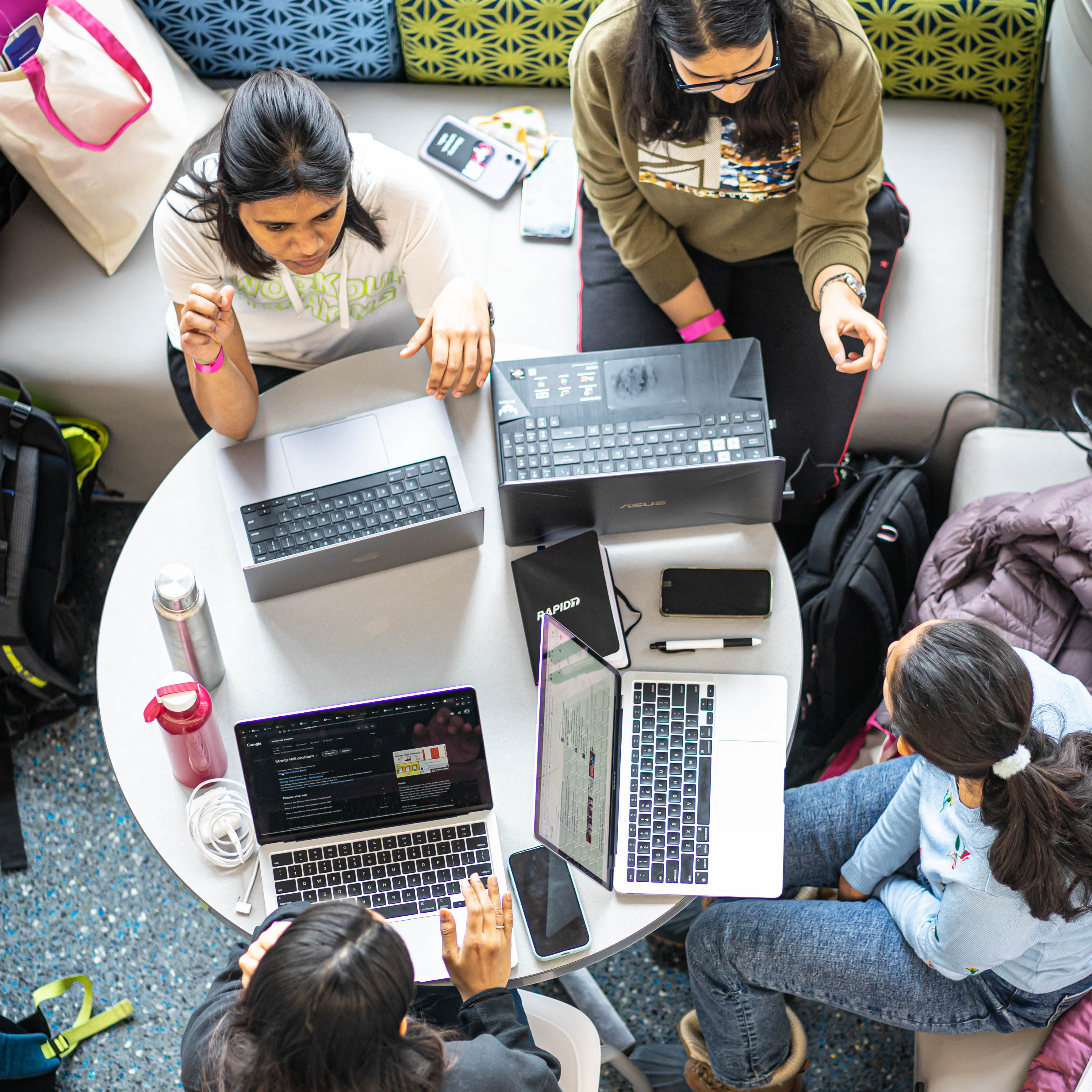 Group of students working on laptops together