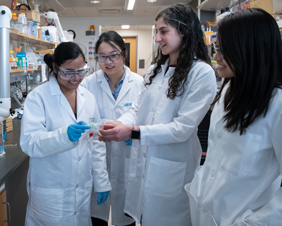 Inaugural Lapidus Fellow Jessica Schiffman, PhD, with a group of now-former PhD students who have gone on to careers as industrial engineers. Pictured from left to right: Prerana Rathore ’24 PhD, Xiangxi (Zoey) Meng ’21 PhD, Schiffman, and Emily Diep ’24 PhD.