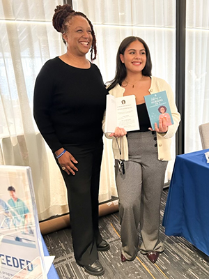 Seedworks Health Equity in Nursing Program Director Lucinda Canty, left, and Ayannah Burgos ’26 at the 2024 New England Minority Nursing Leadership Conference, where Burgos was promoting the book Latinas in Nursing, Vol. 2