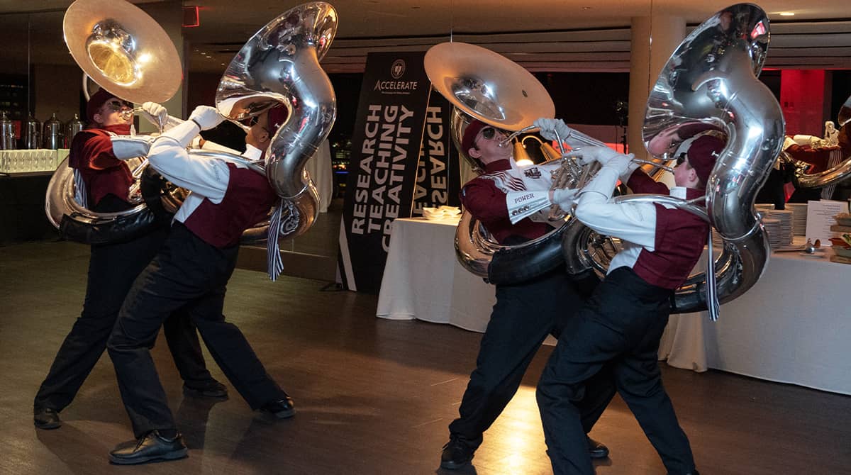 Tubists playing tubas and dancing