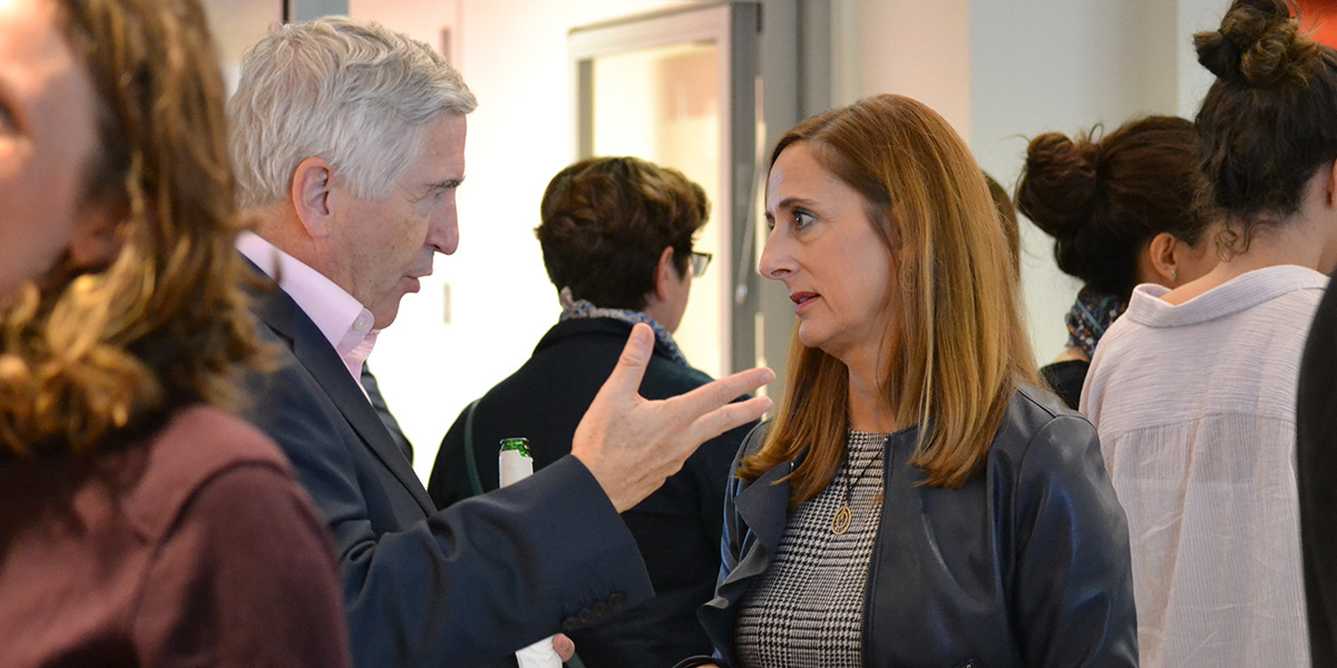 Advisory council member John Brooks speaking to Dean Anna Maria Siega-Riz.