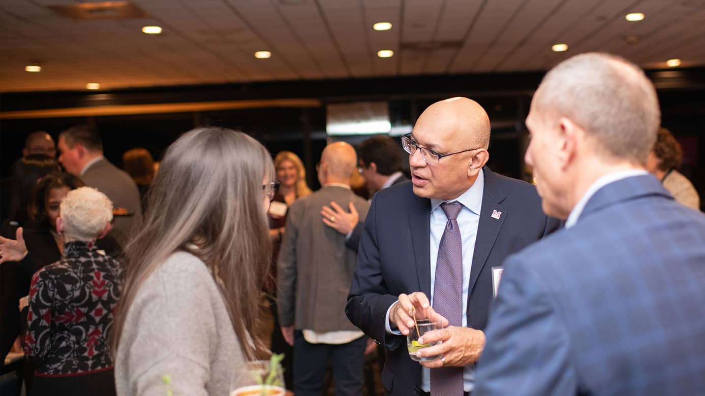 Dean of the College of Engineering speaks with guest at Accelerate event