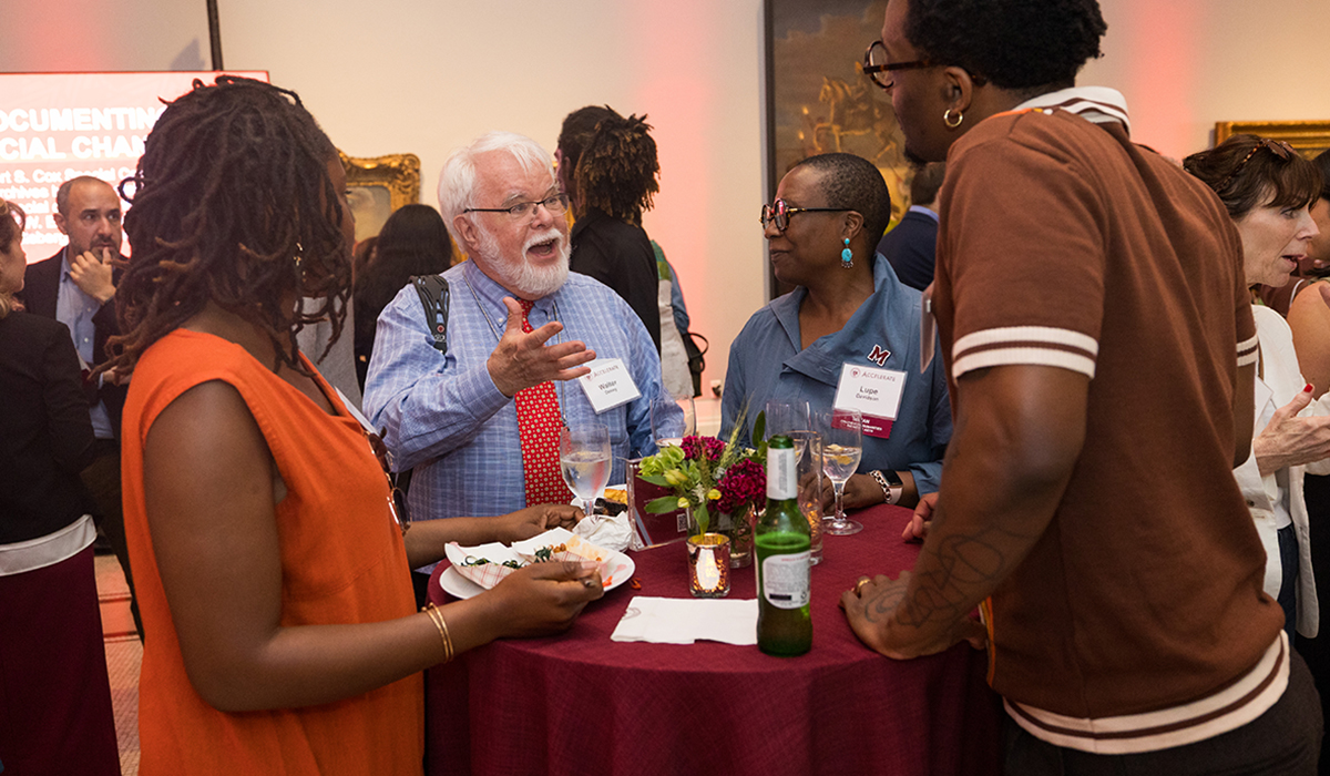 Lupe Davidson, PhD, Dean of the College of Humanities and Fine Arts, talking to attendees.